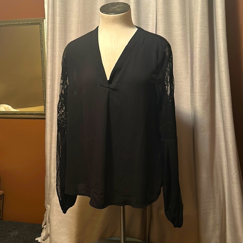 Loose large fitting shein black top with lace work at the sleeves.